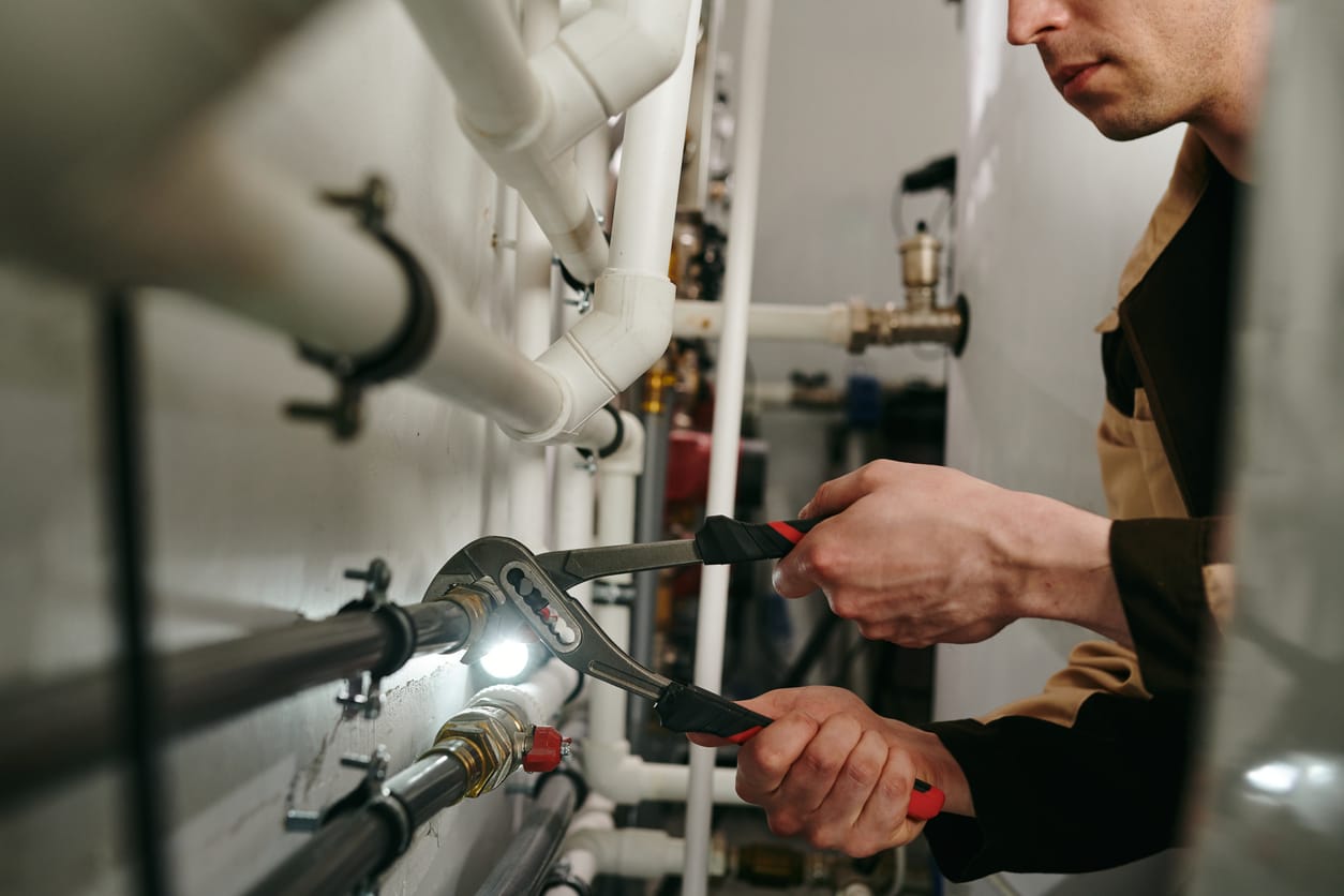 Plumbers maintaining commercial plumbing pipes in Greenacres