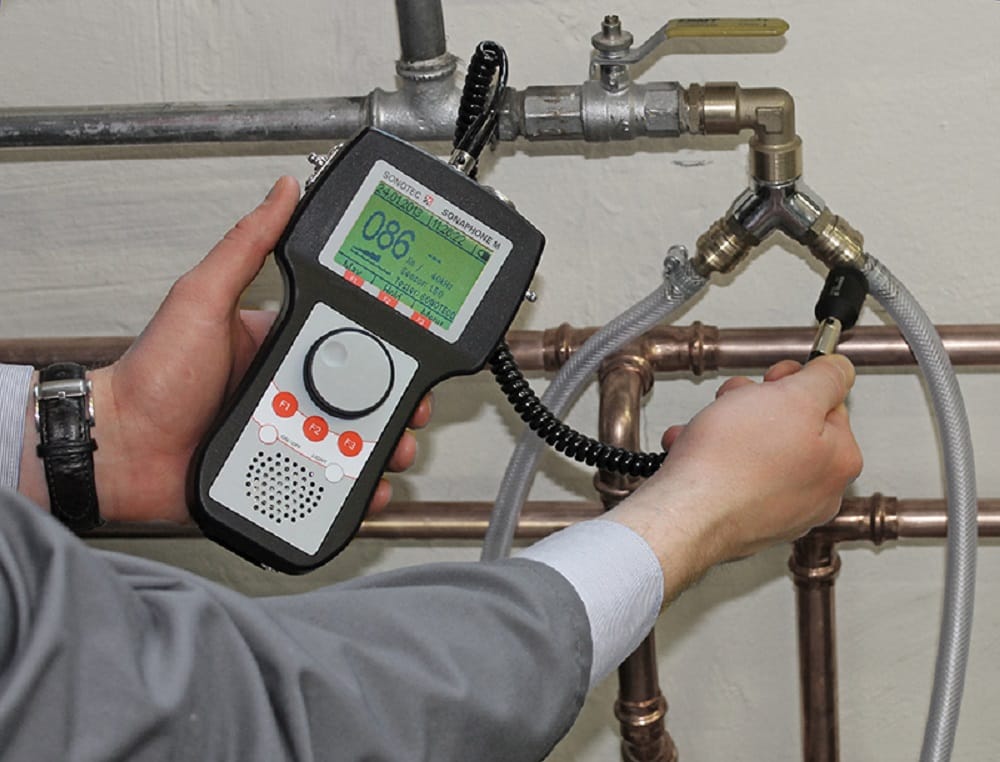 Plumber testing pipes with electronic leak detection equipment in Greenacres