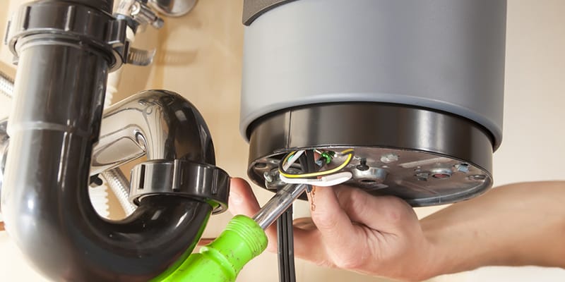Technician repairing the heating element of a water heater in Greenacres