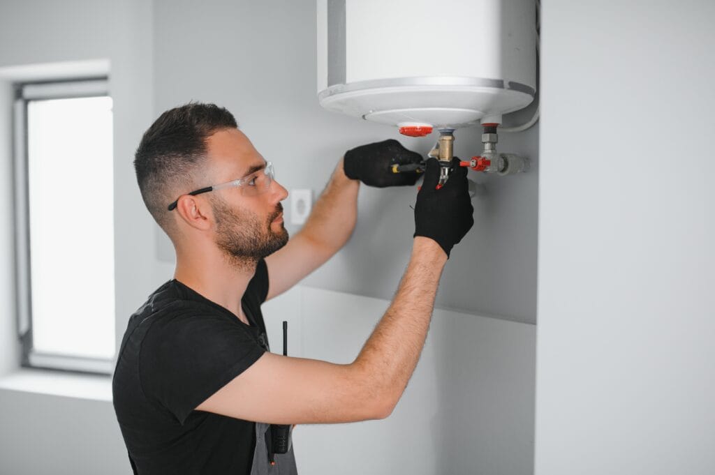Technician performing water heater maintenance in Greenacres